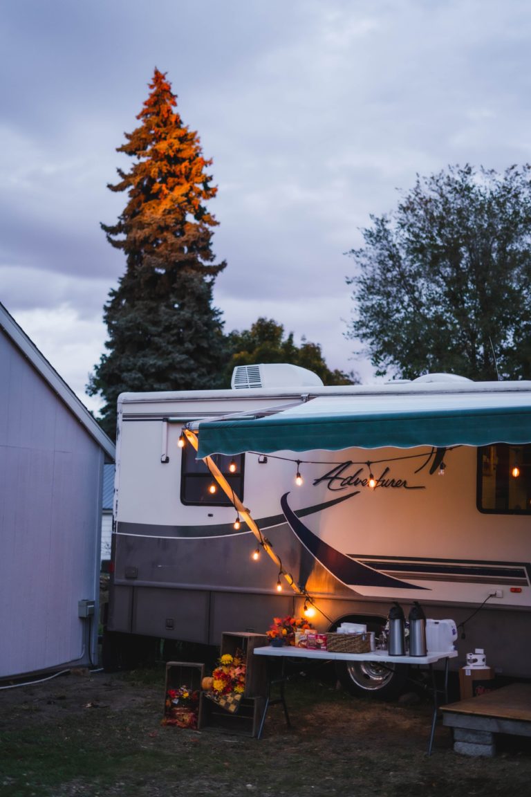 rv with extended awning at night