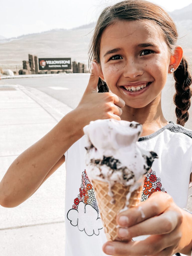 Little girl smiles with ice cream cone