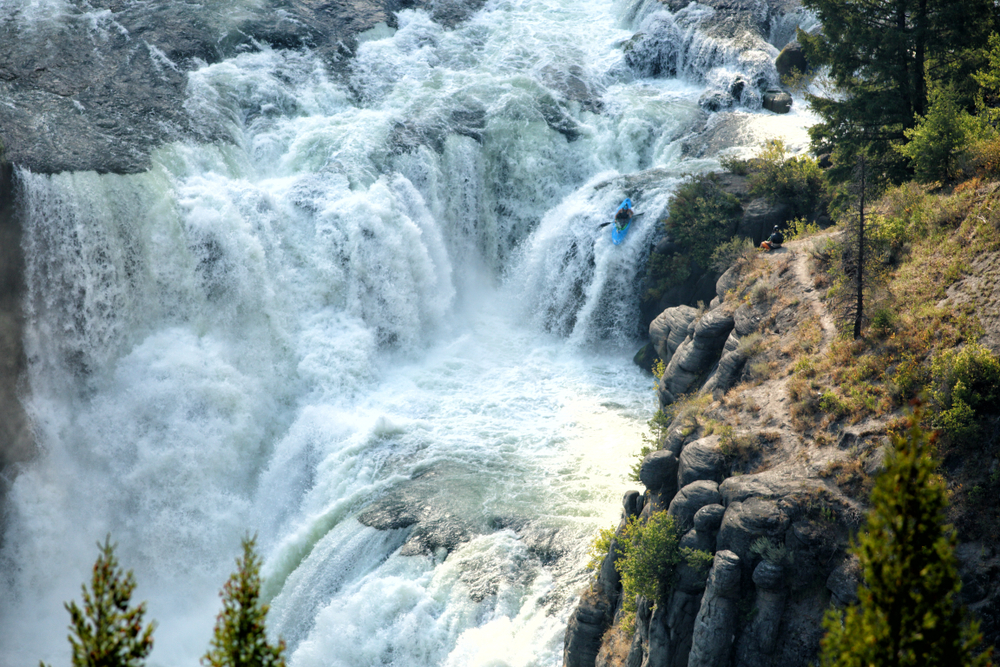 An experienced kayaker challenges the raging rapids of lower Mesa Falls on the Henry's Fork of the Snake River, in Idaho.